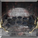 D02. Brass andirons and fireplace candle holder. 